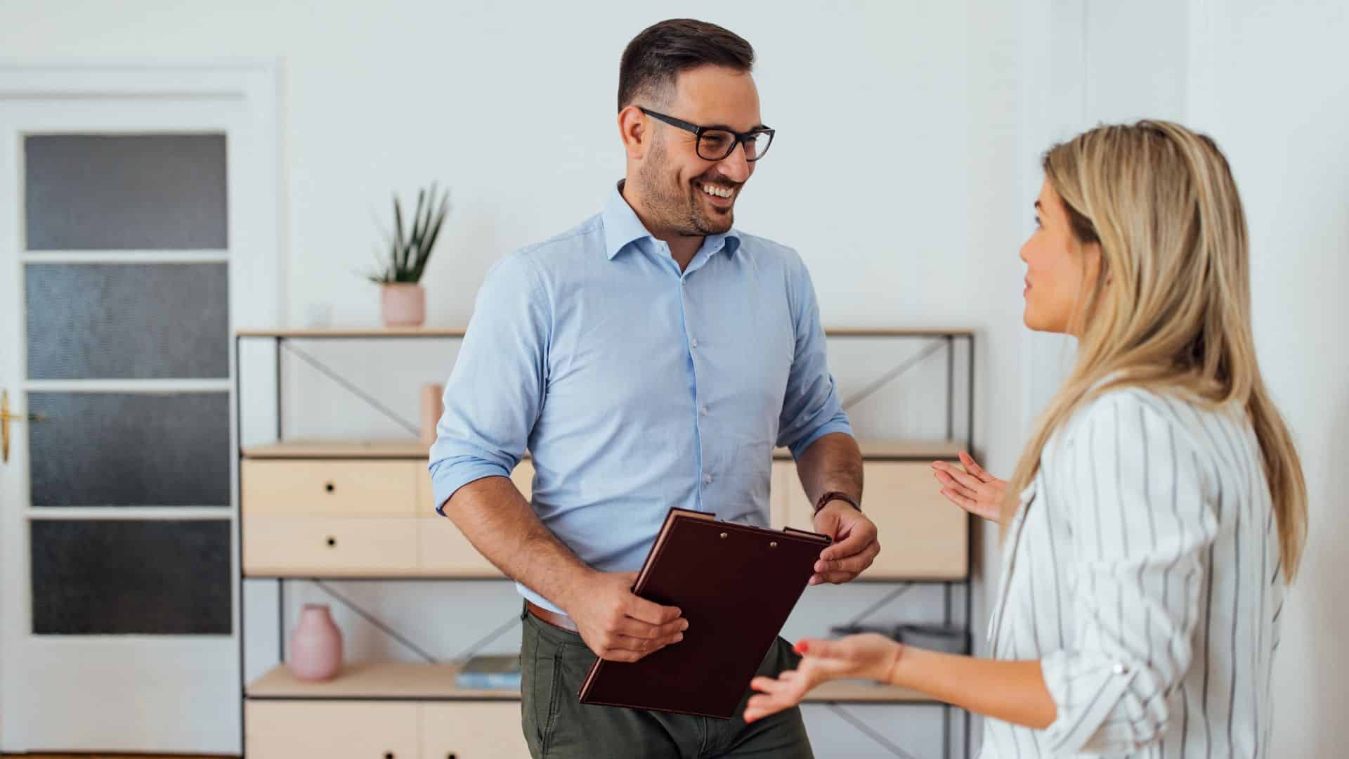 Property manager discussing a clipboard checklist with a Birmingham owner