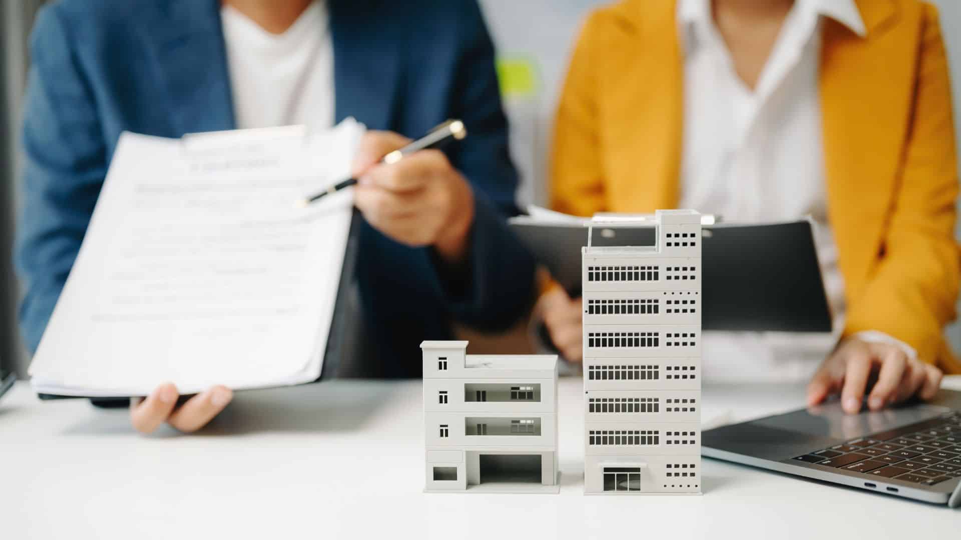 Building model placed beside a compliance support contract