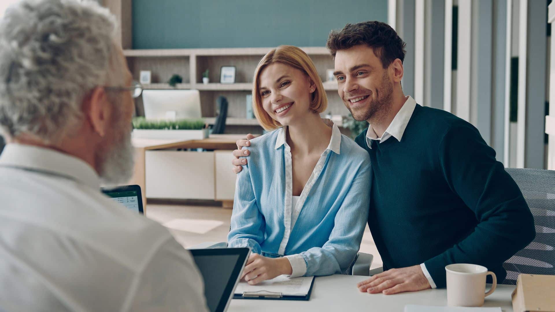 Couple meeting with a property manager in an office consultation