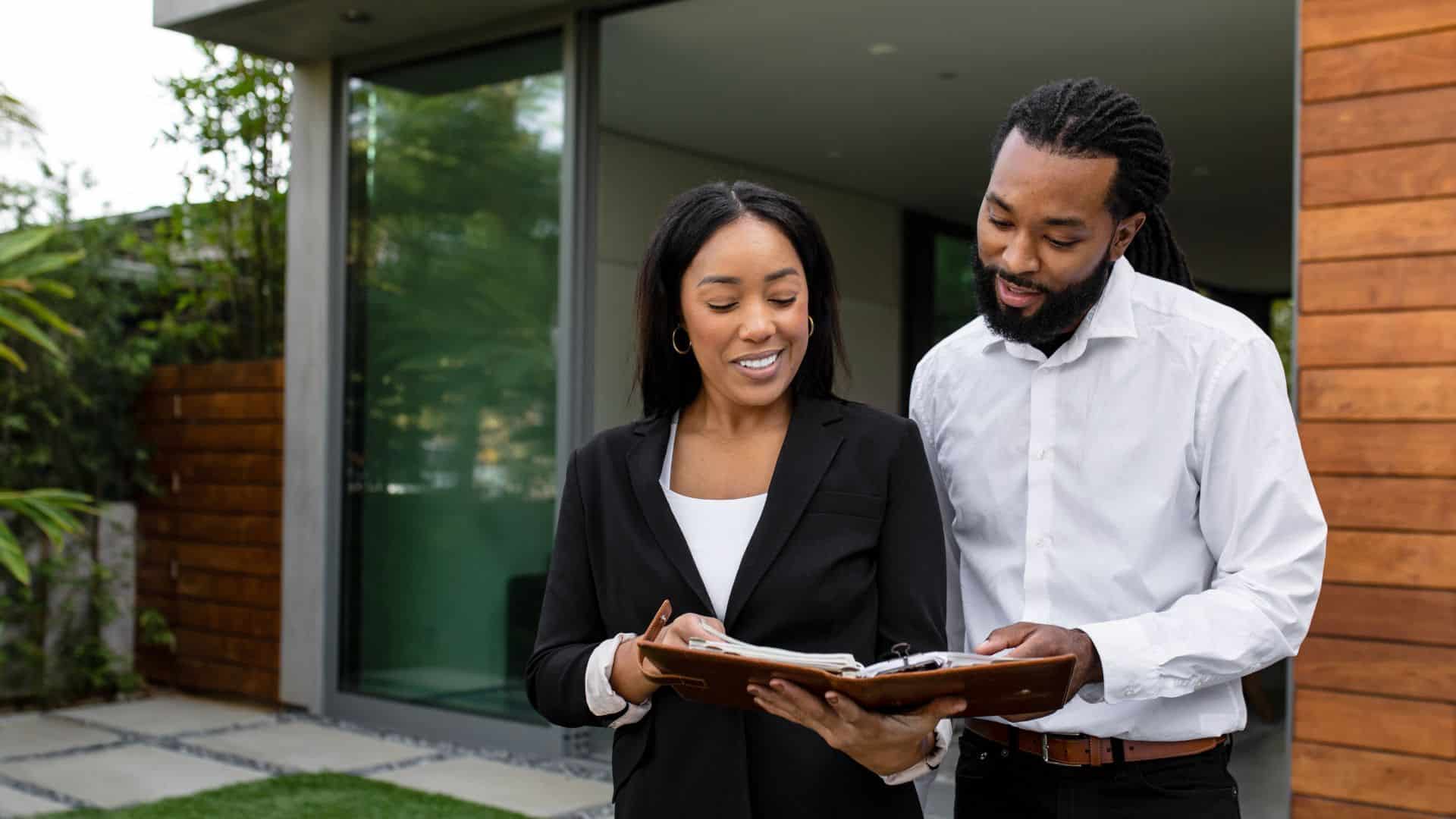 Property owner reviewing paperwork outdoors near a rental property