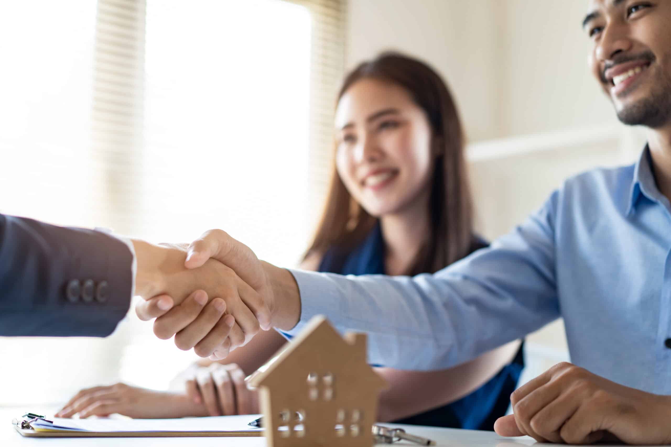 Property manager and tenant shaking hands after a successful lease agreement