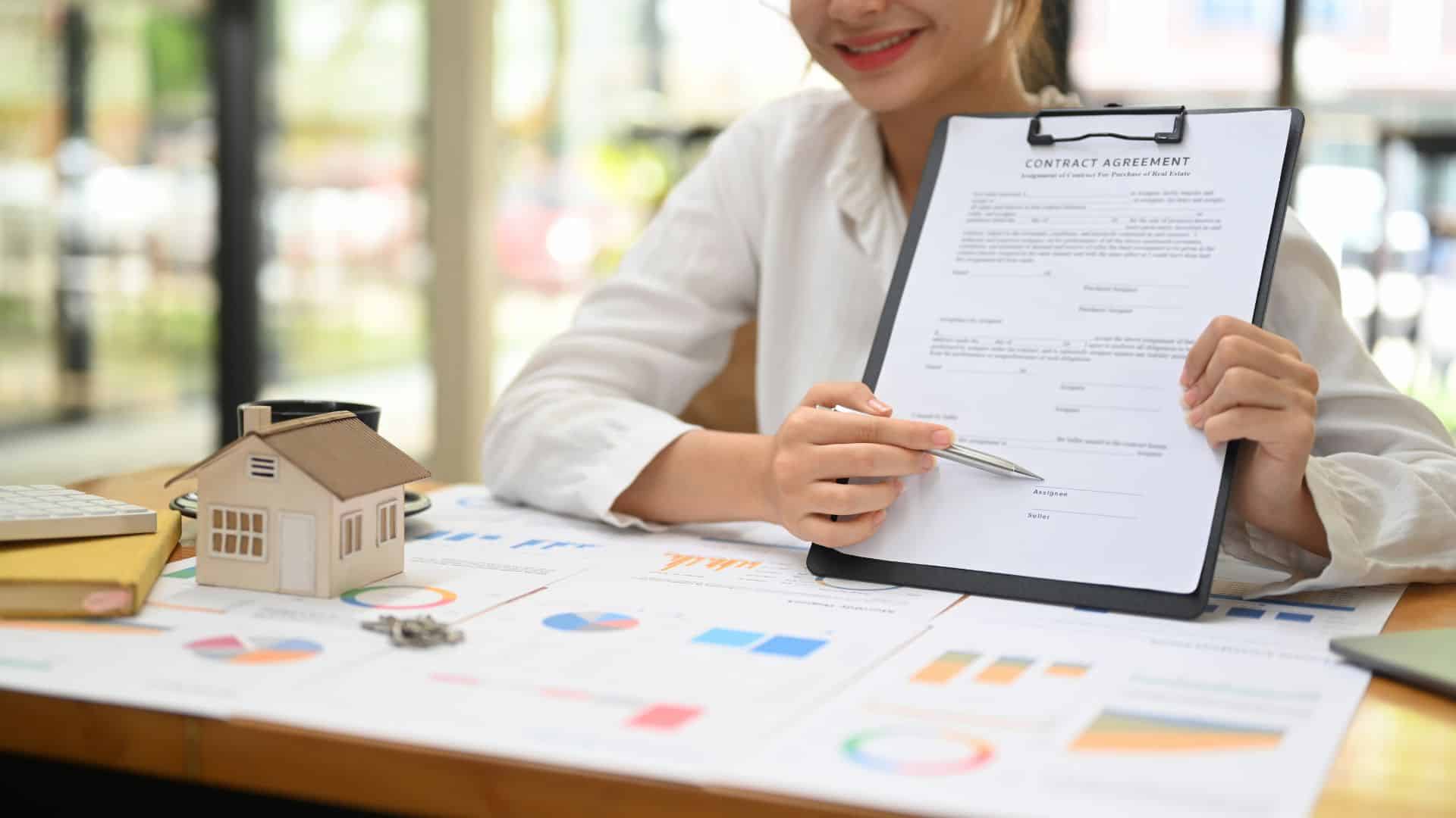 Property manager reviewing a rental agreement alongside financial charts