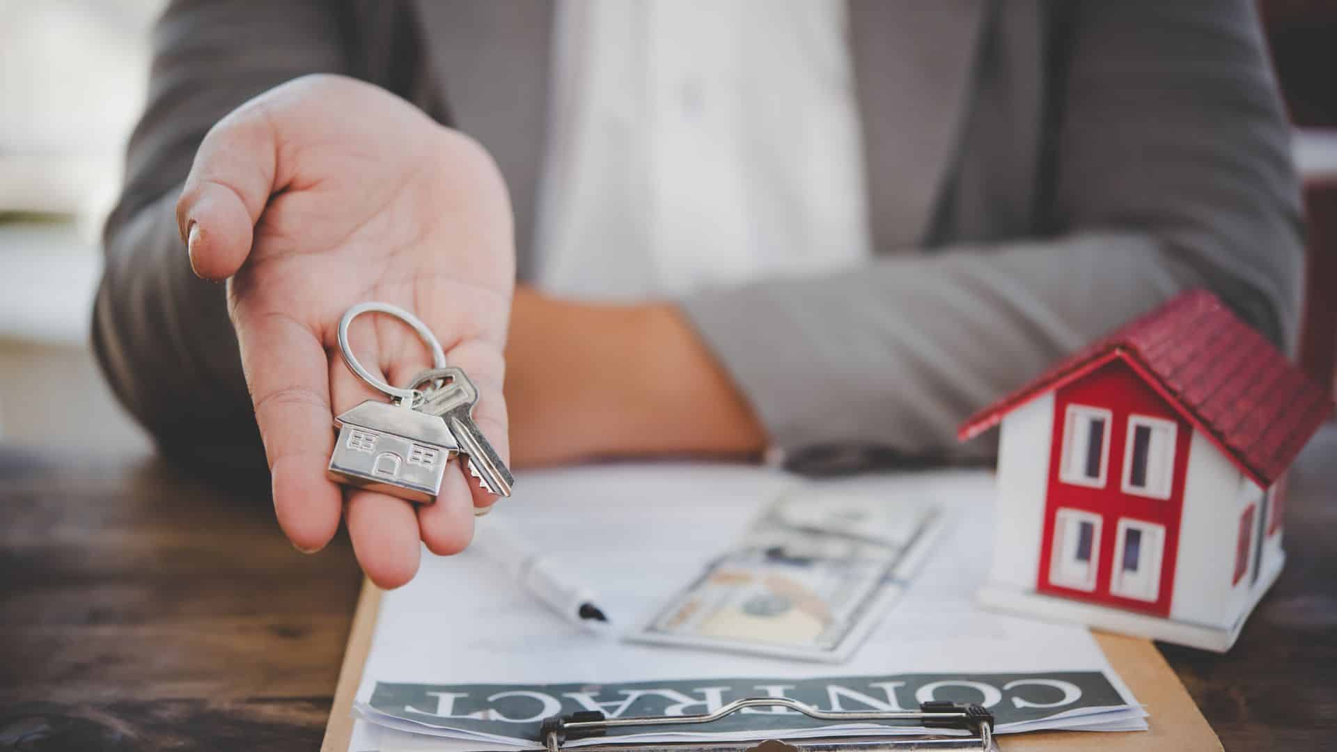 House key resting on a signed rental contract