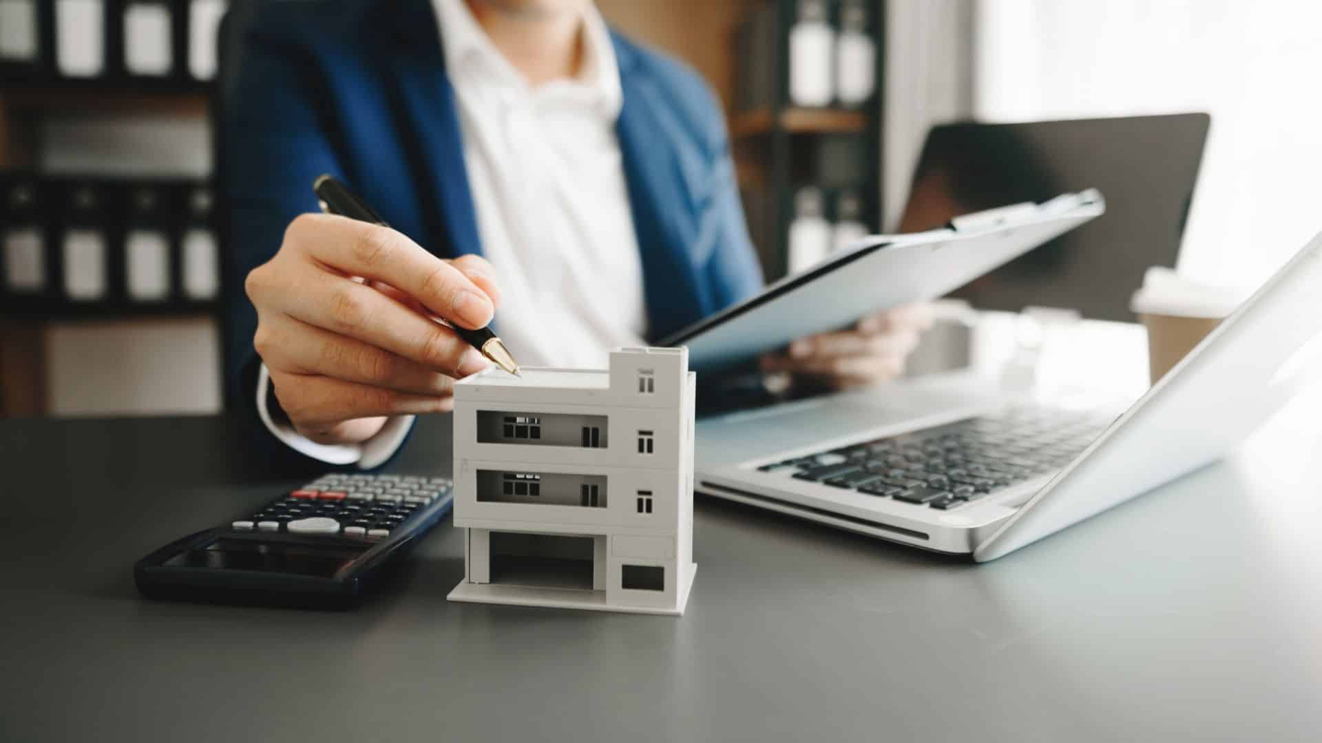 Building model on a desk during a Tarrant property management consultation