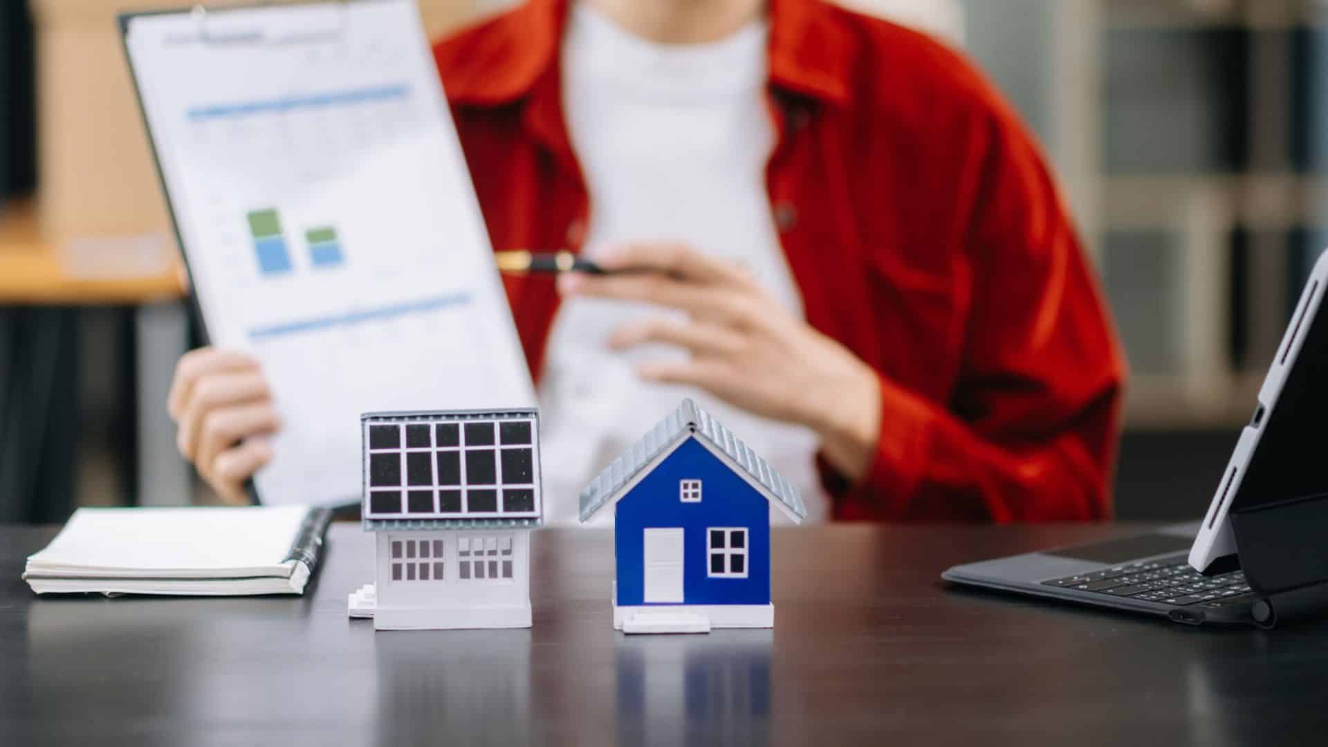 House models and a performance chart on a desk for Tarrant property management