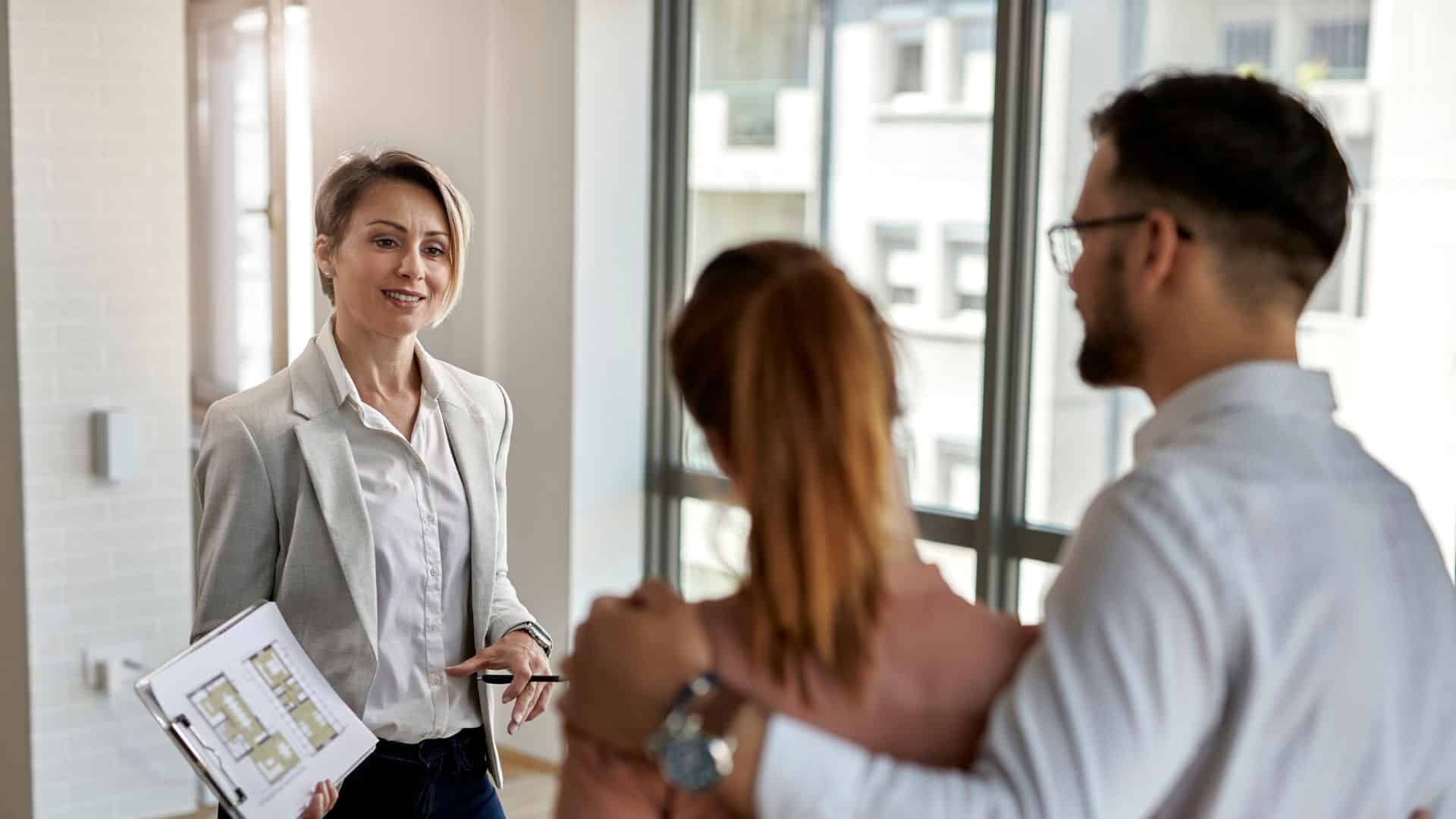 Property manager reviewing a floor plan during a tenant screening consultation